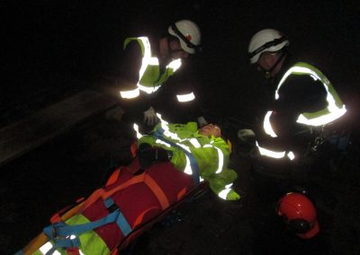 Injured person secured into rescue stretcher for confined space rescue