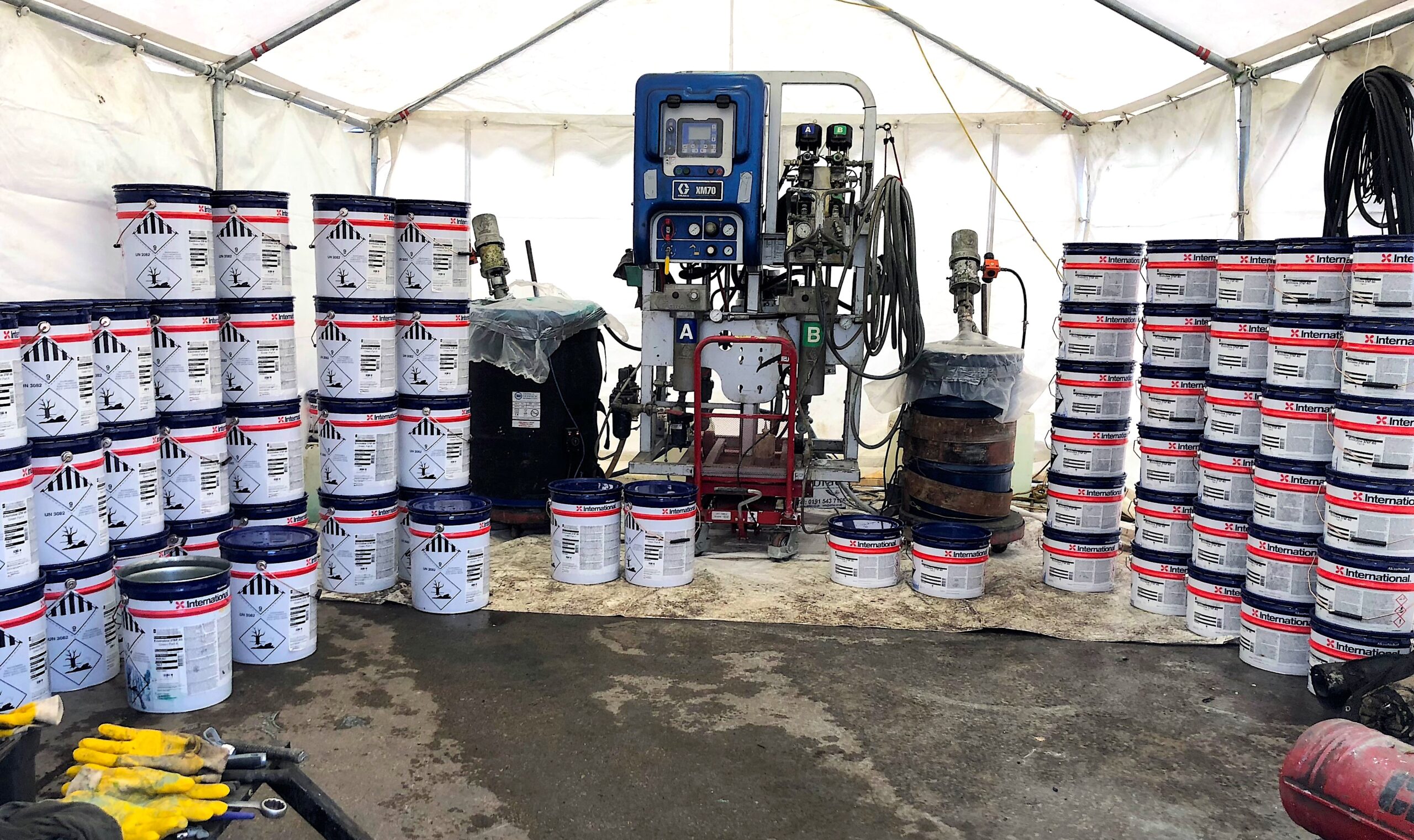 Heated plural component spray machine set-up on site